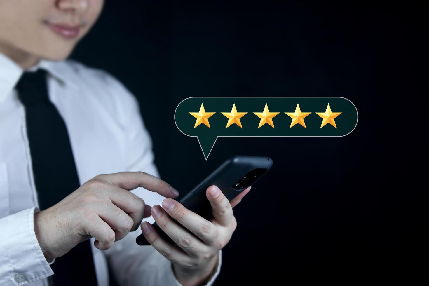 Service Rating Customer satisfaction ratings, feedback, or positive reviews. Customers use smartphones to rate five stars. satisfy service.  ratings are very impressive photo