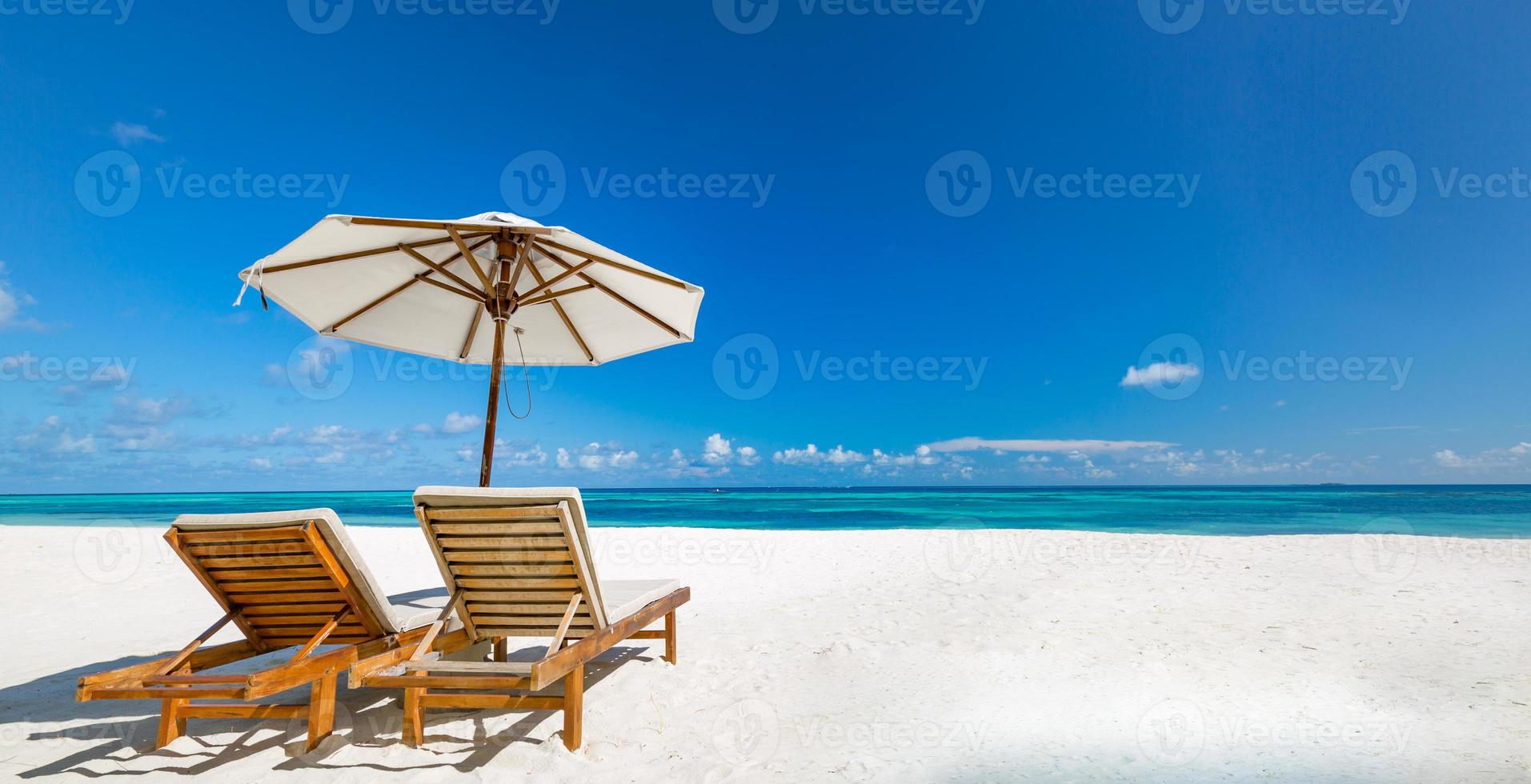 Beautiful tropical beach banner. White sand and coco palms and beach chairs as wide panorama background concept. Amazing beach landscape, romantic scene for couple or honeymoon travel destinations photo