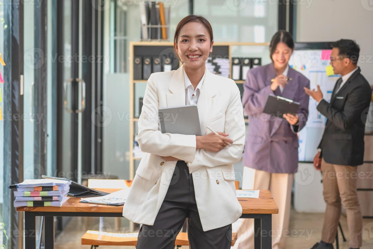 Marketing, Financial, Accounting, Planning, Asian businesswoman team leader with beautiful leaves smiles showing joy after successful company work. photo