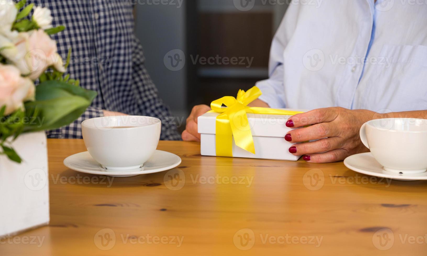 Holiday celebration. 8 march,birthday,international women day,mother's day.Unrecognizable senior woman holding gift photo