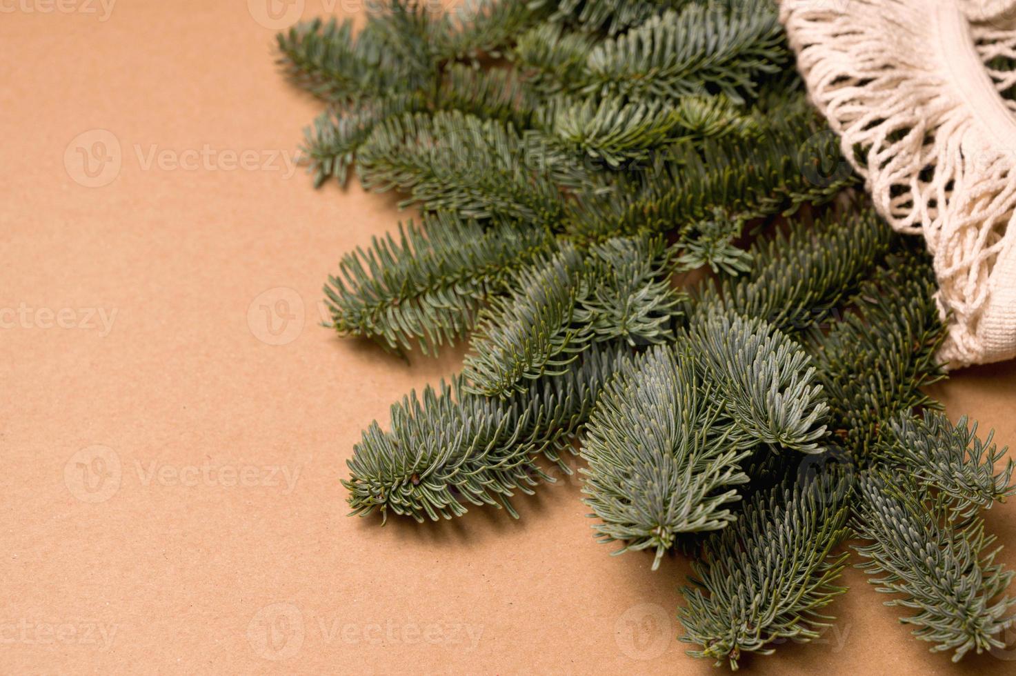 Closeup of fir tree brances in eco-friendly bag. Sustainable and aero waste winter holidays concept.Mockup photo