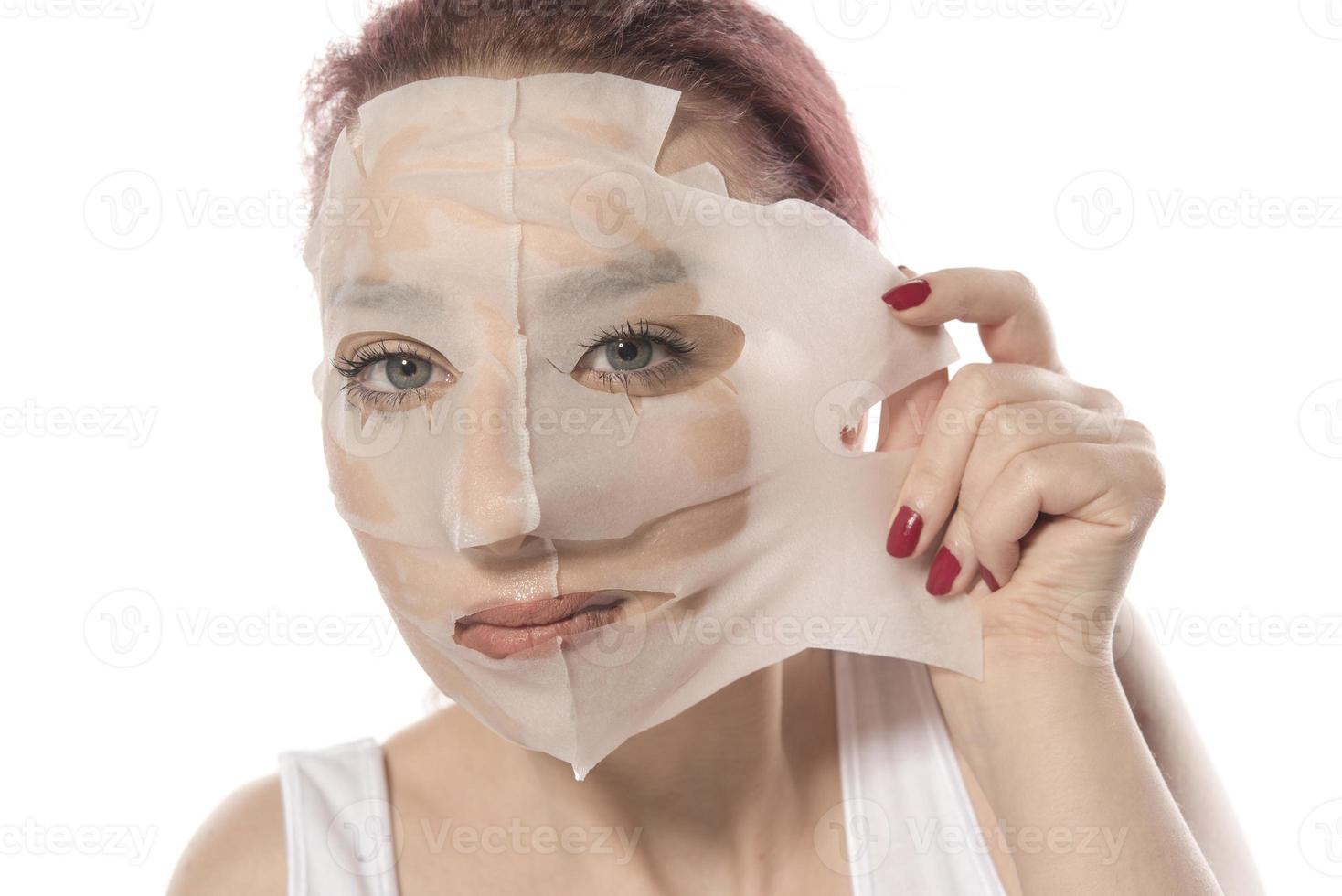 Cosmetic procedure. Woman's face with white cosmetic mask photo