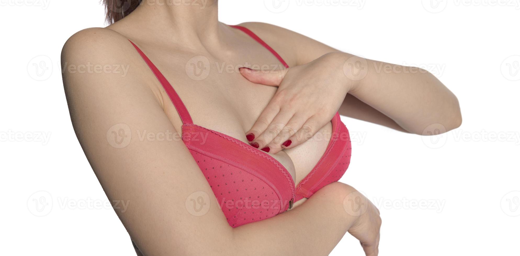 Breast screening. Young woman examining her breasts, cancer prevention, closeup photo