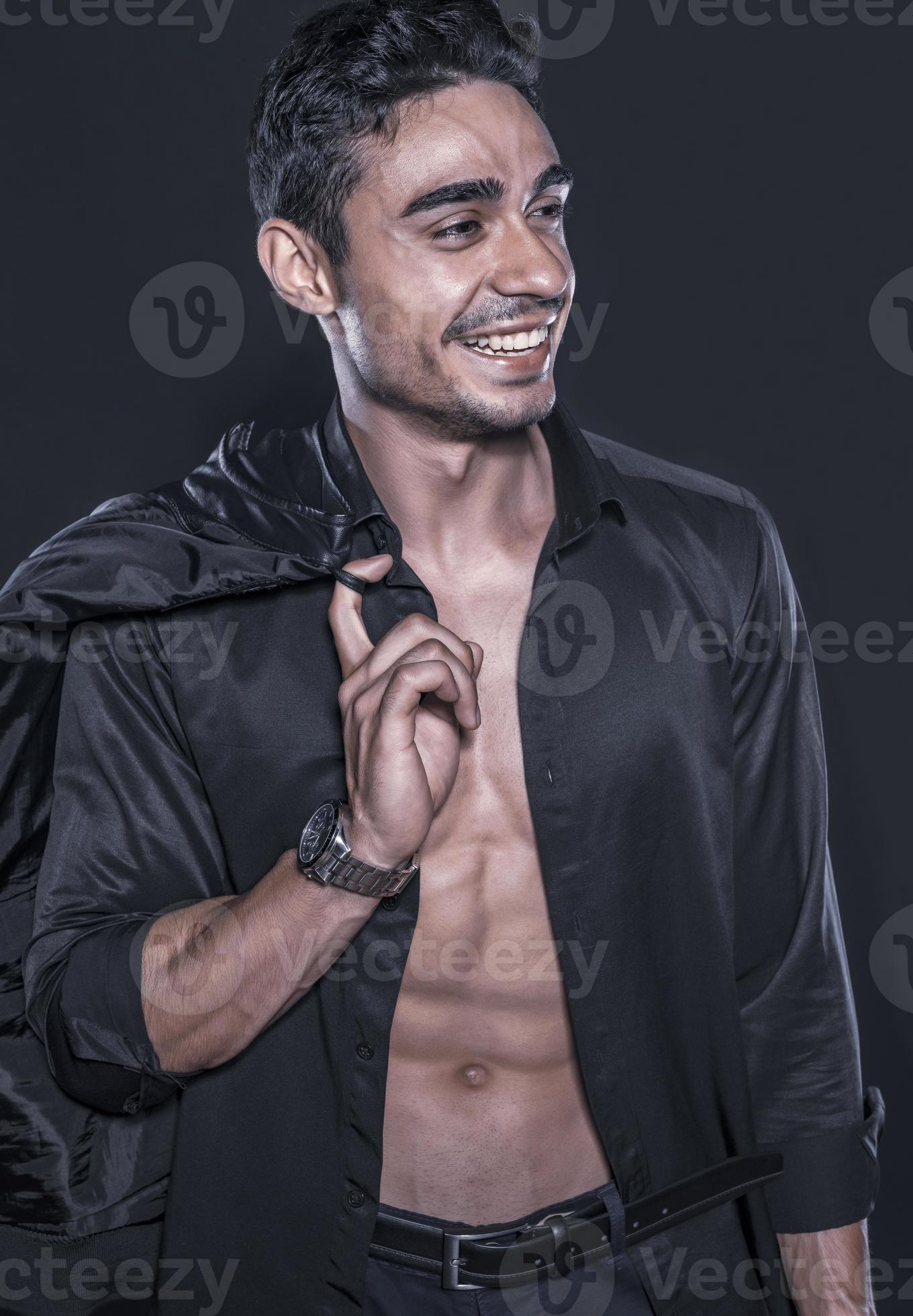 Handsome Arab male model with perfect body posing in studio. Portrait