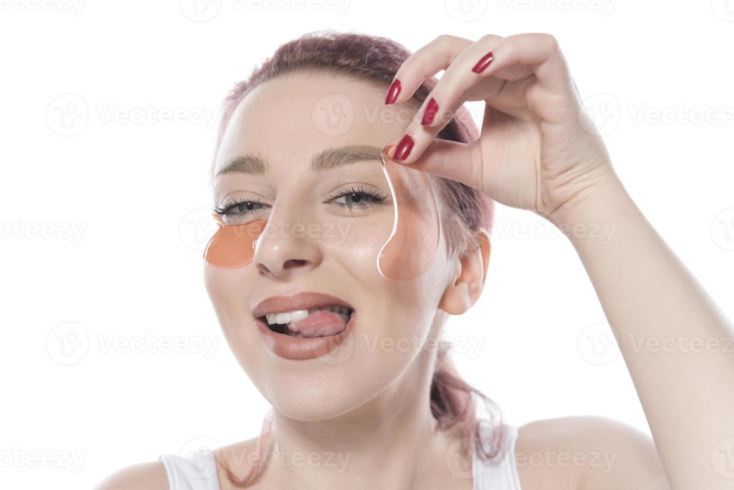 with cosmetic patches moisturizing on skin under eyes. isolated on white background photo