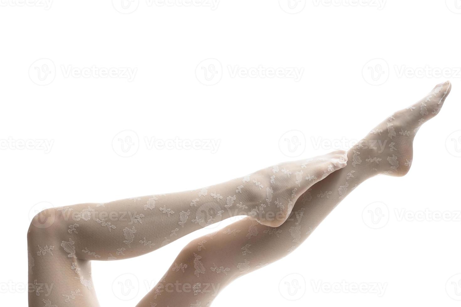 Beautiful slender women's legs wearing tights on a white background photo