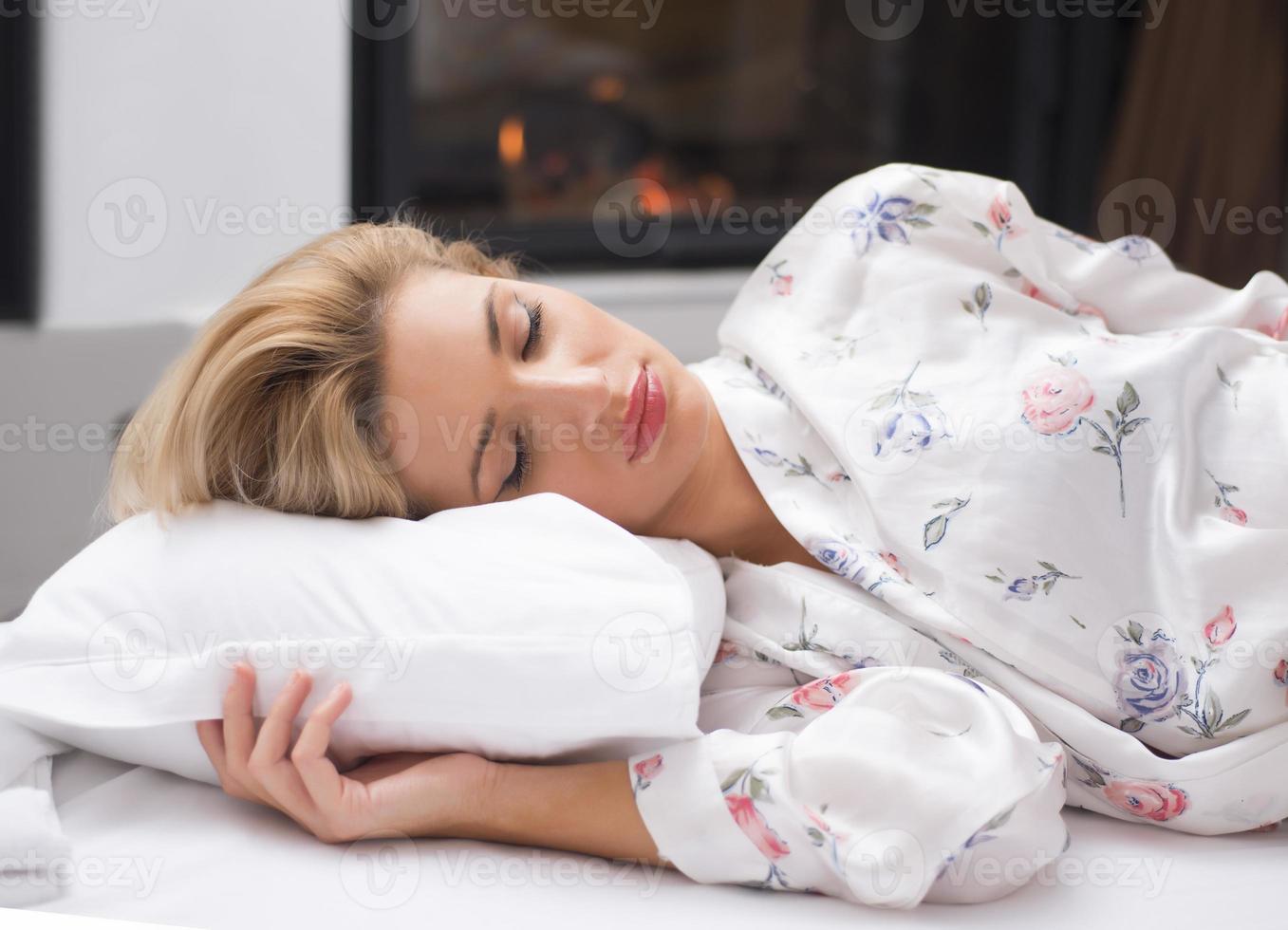 Young girl sleeping in her bed photo