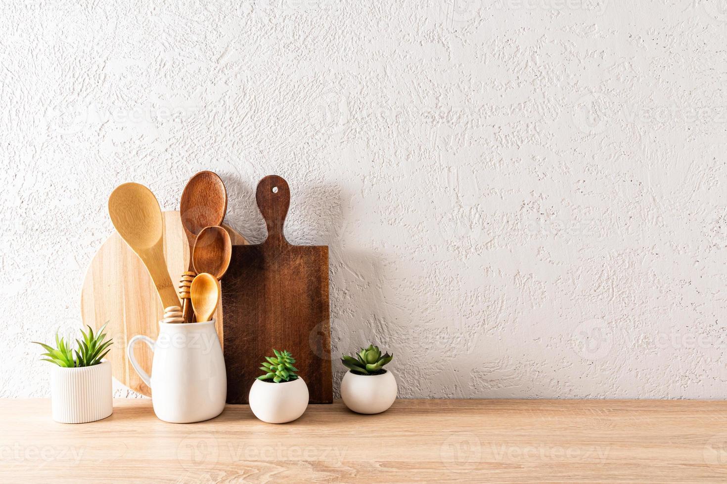 fondo de cocina para el diseño con tablas de cortar, cucharas de madera en la jarra y plantas de interior en maceta. minimalismo una copia . foto