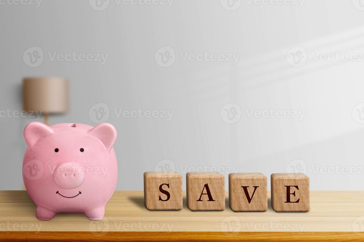 the piggy bank and the SAVE letter box on the bedroom table photo