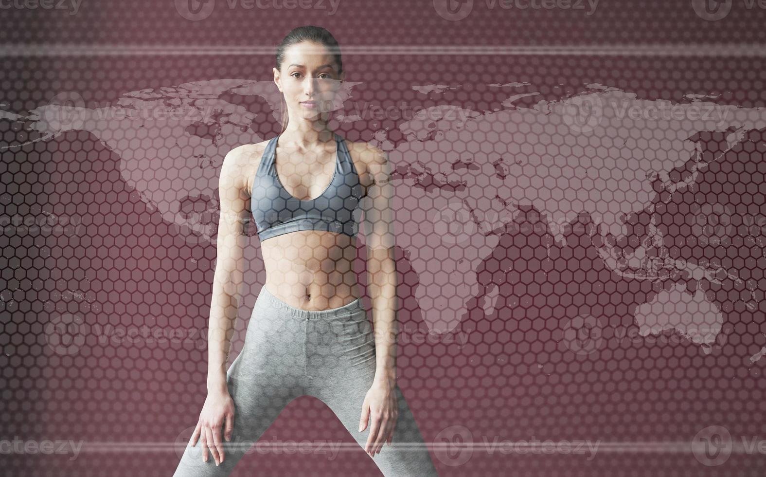 Digital world map on picture. Young woman with slim body shape in sportswear have fitness day indoors photo