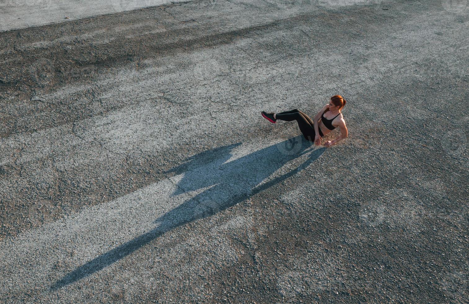 Top view of woman that have fitness day on the road at evening photo