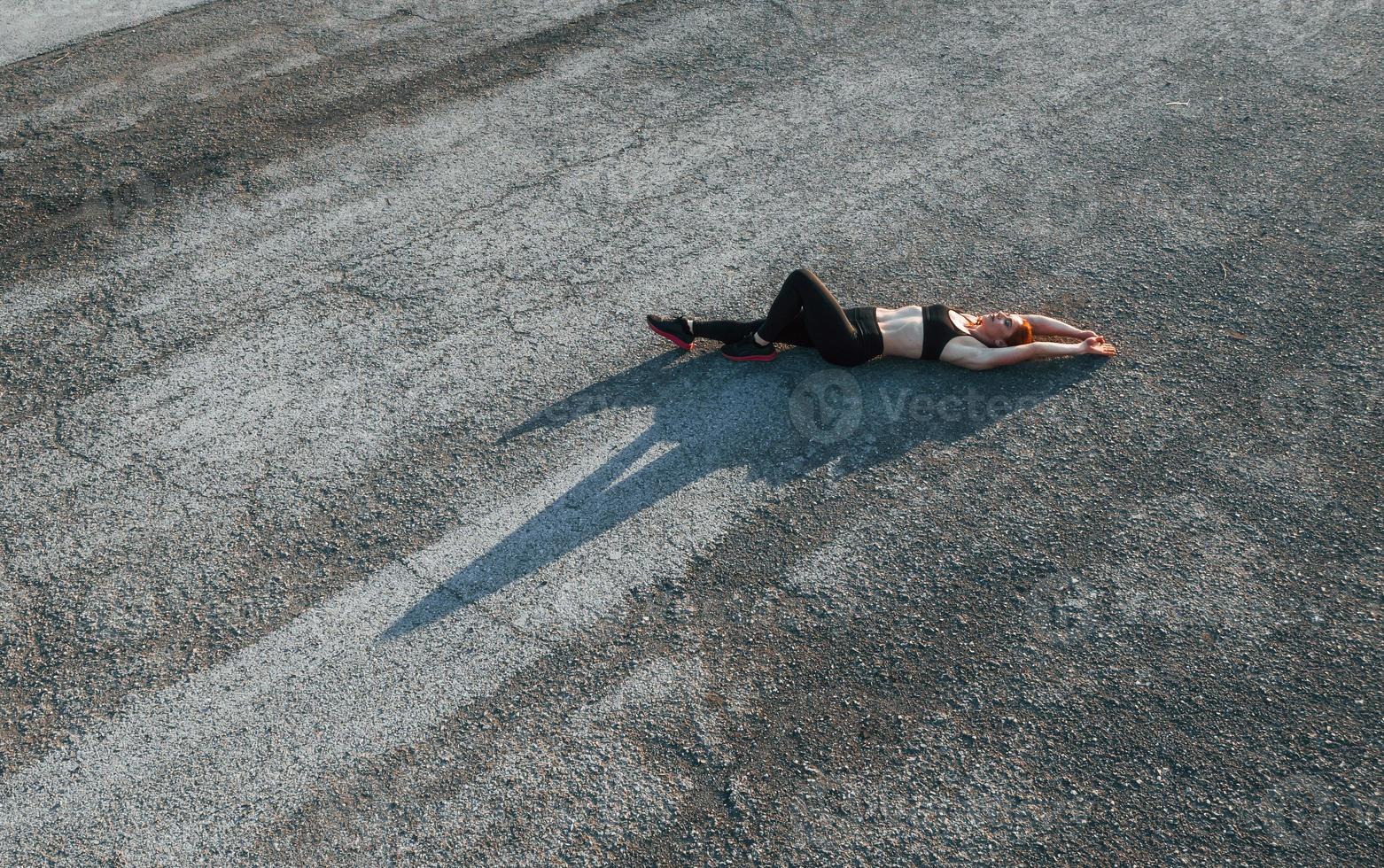 Top view of woman that have fitness day on the road at evening photo