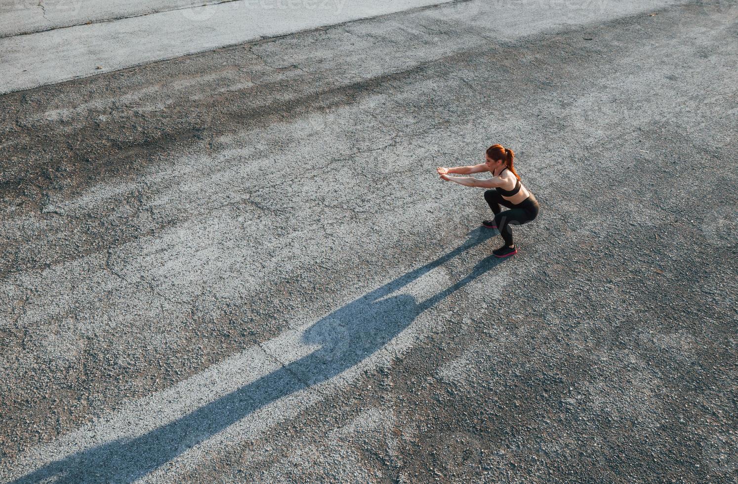 Top view of woman that have fitness day on the road at evening photo