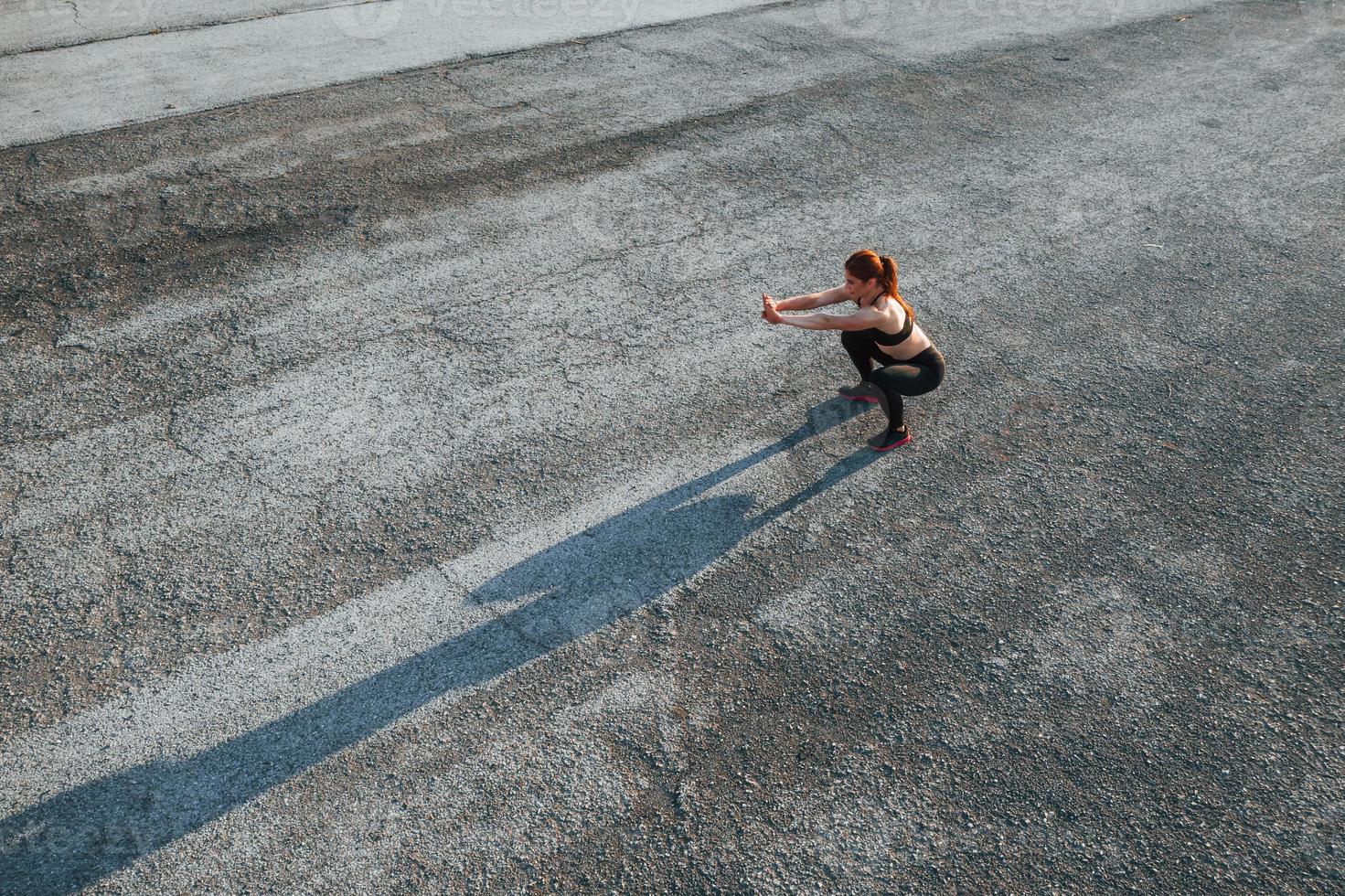 Top view of woman that have fitness day on the road at evening photo