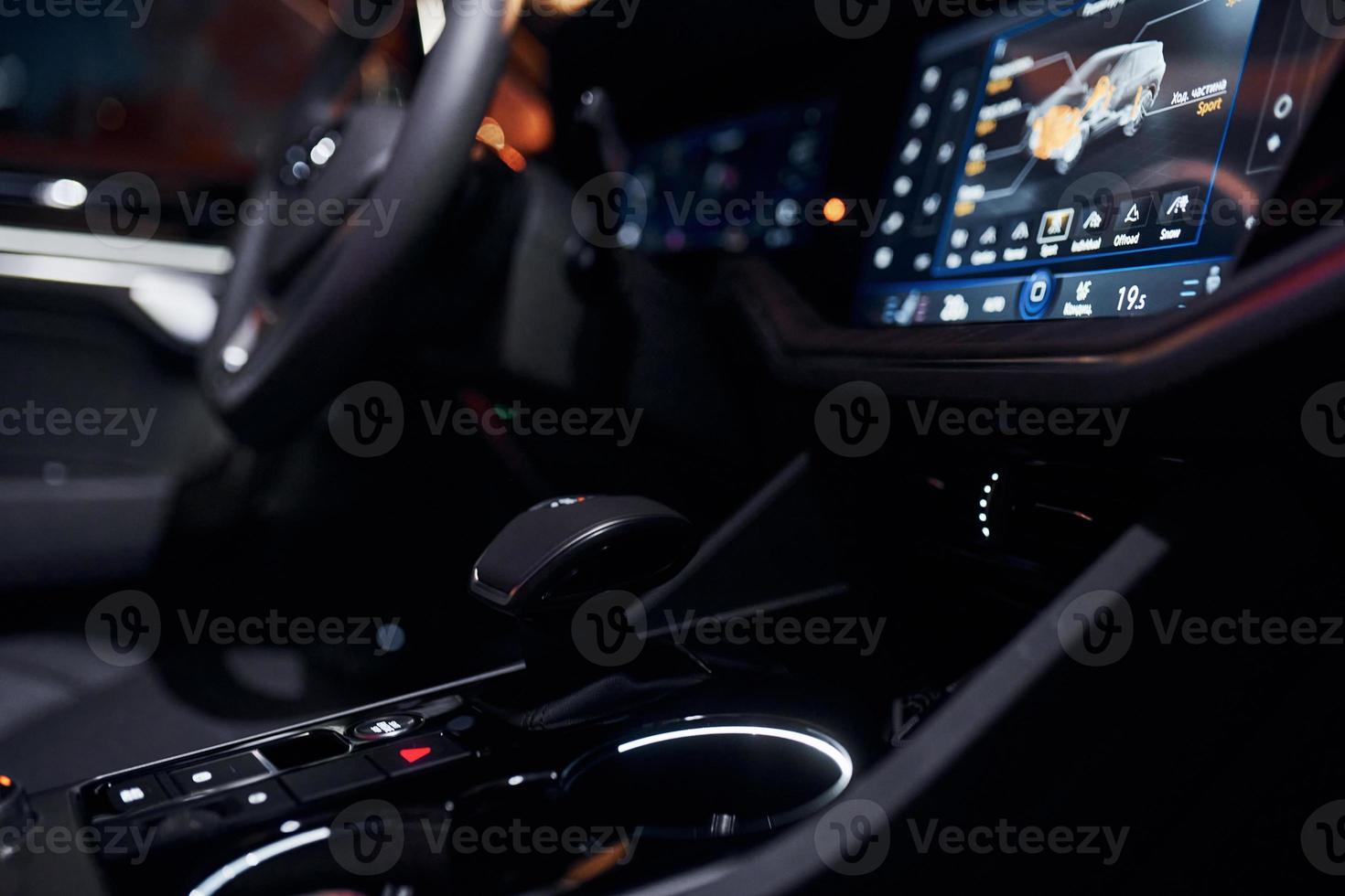 Steering wheel and navigation display. Close up view of front park of new modern black automobile photo