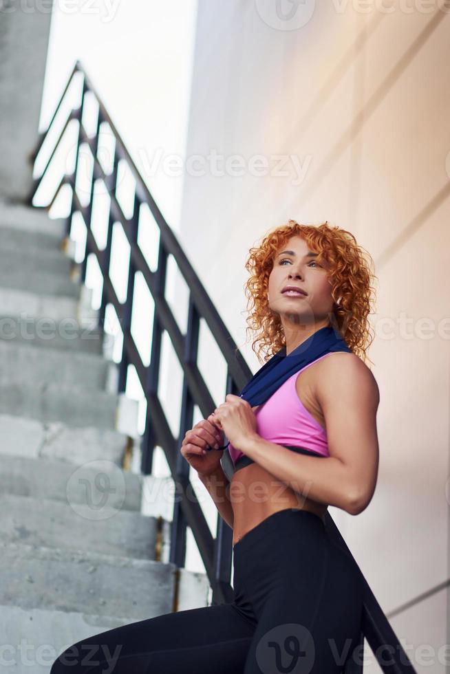 Young, European, muscular girl in red leggings, doing exercise