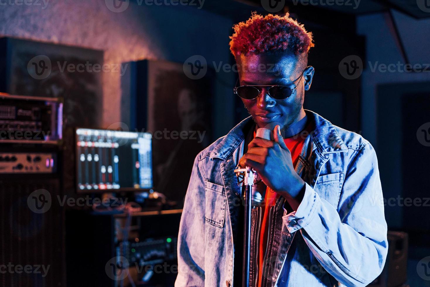 Young african american performer rehearsing in a recording studio photo