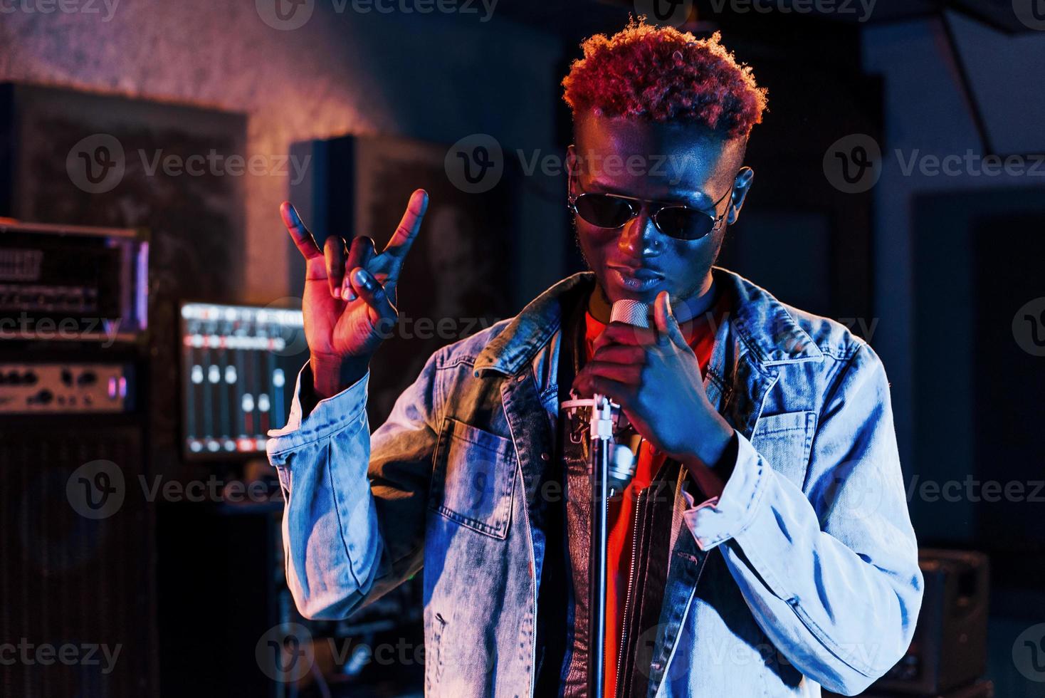 Young african american performer rehearsing in a recording studio photo