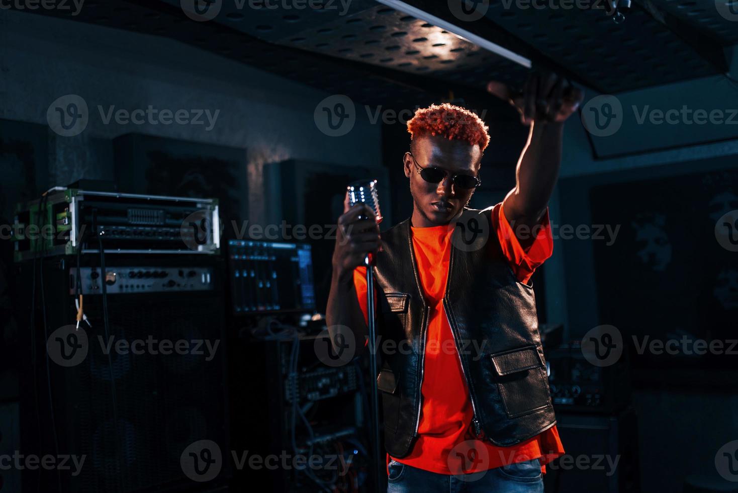 Young african american performer rehearsing in a recording studio photo