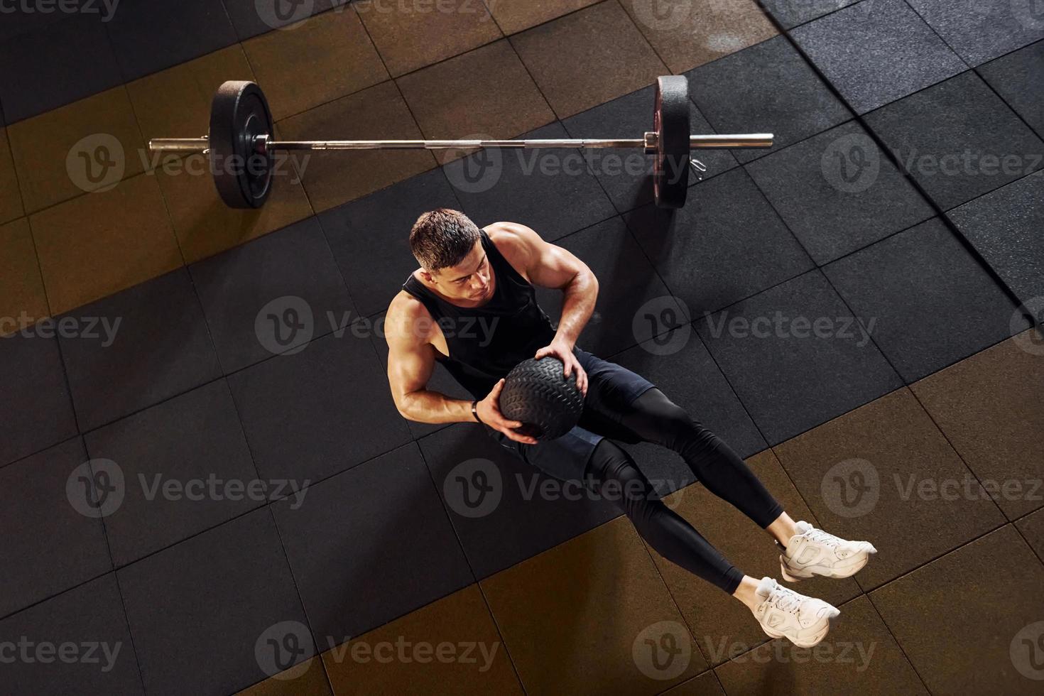 Top view of strong man in sportive clothes that have workout day in the gym photo