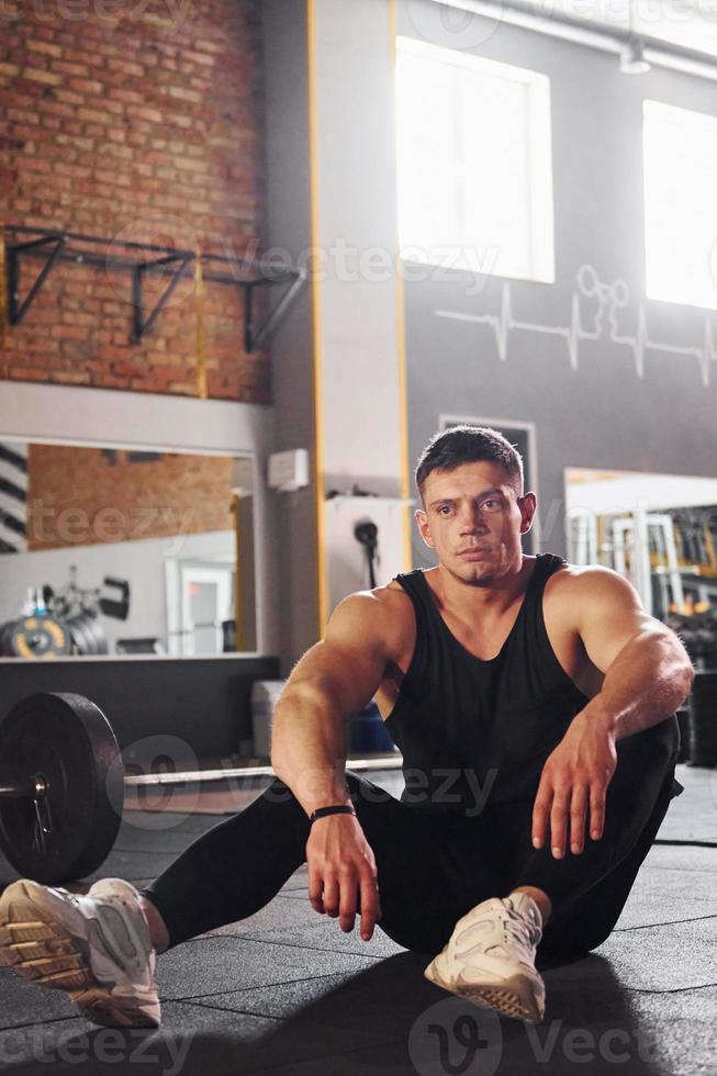 Strong man in sportive clothes have workout day in the gym photo