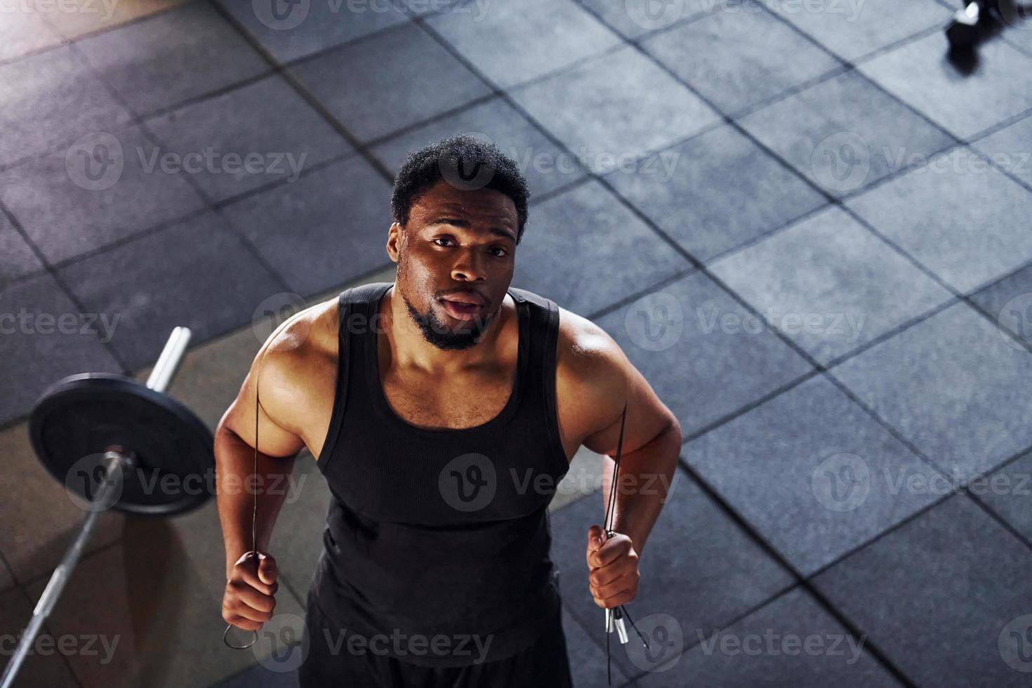 vista superior. barra en el suelo. un hombre afroamericano fuerte con ropa  deportiva tiene un día de entrenamiento en el gimnasio 15293830 Foto de  stock en Vecteezy