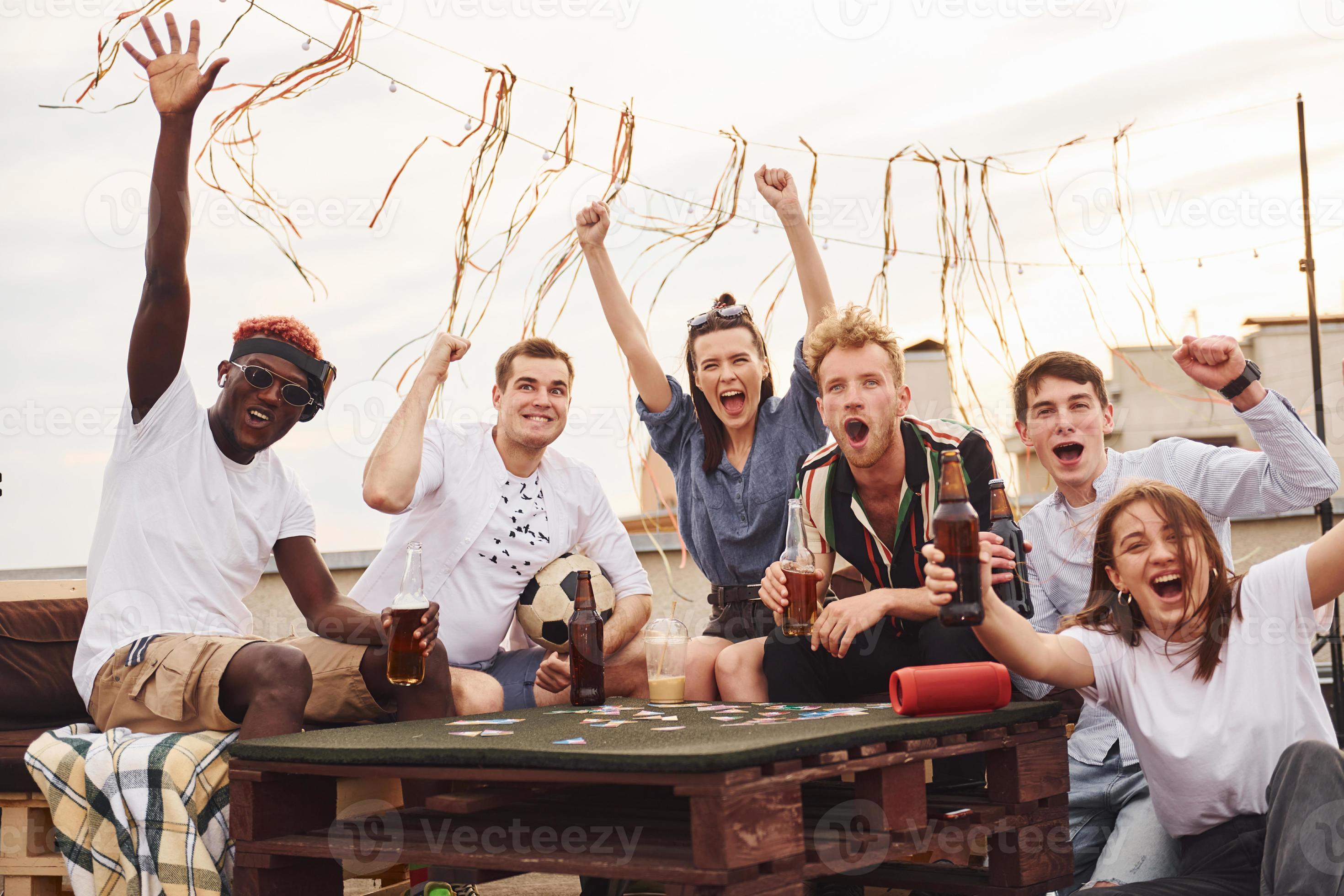 Playing card game. Group of young people in casual clothes have a party