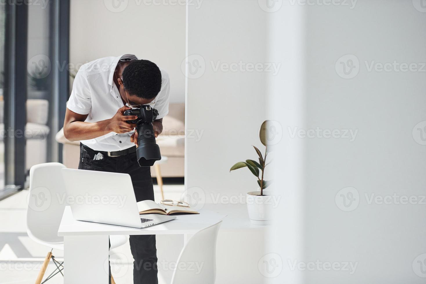 Testing camera. Young african american man in formal clothes is in the office photo
