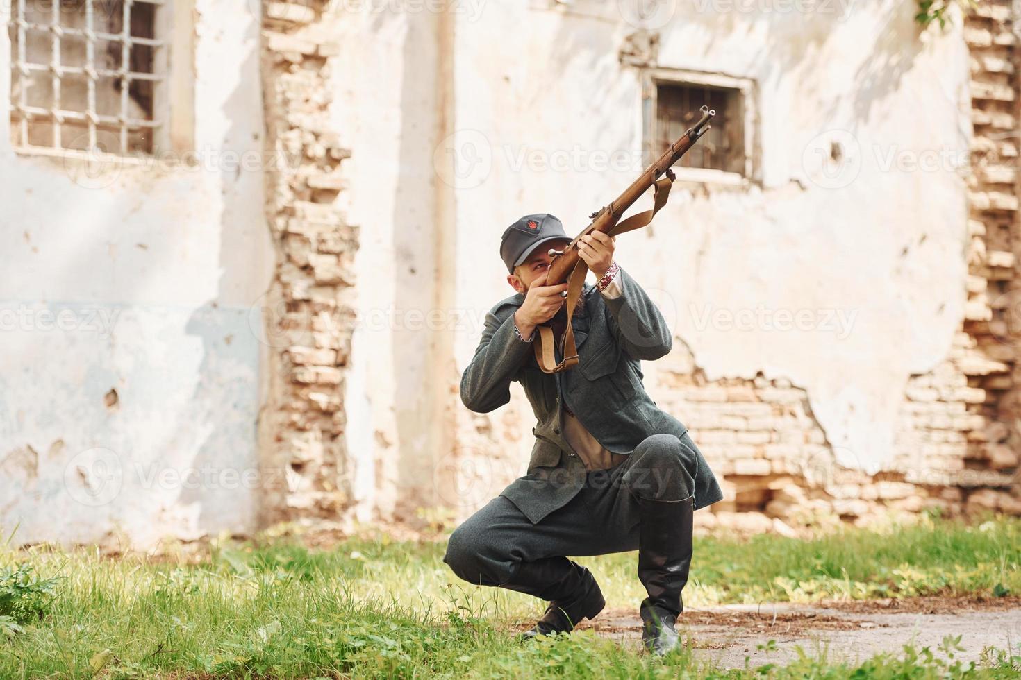 TERNOPIL, UKRAINE - June 2020 UPA Ukrainian Insurgent Army movie filming. Pictures of backstage. Young soldier with weapon near old building photo