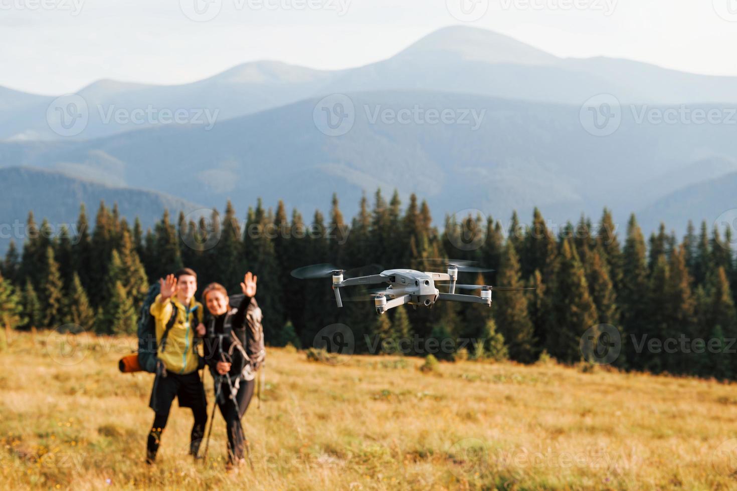 Drone flying near young travelers. Majestic Carpathian Mountains. Beautiful landscape of untouched nature photo