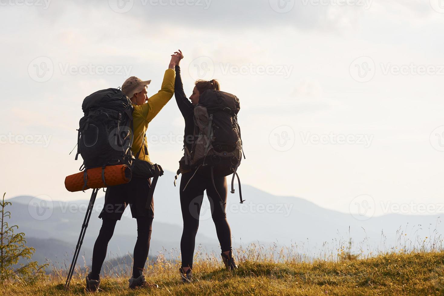 Couple conquested that hill. Majestic Carpathian Mountains. Beautiful landscape of untouched nature photo