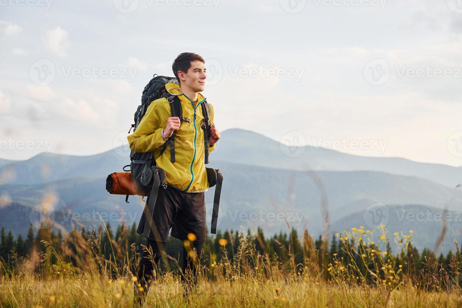 Cheerful young traveler. Majestic Carpathian Mountains. Beautiful landscape of untouched nature photo