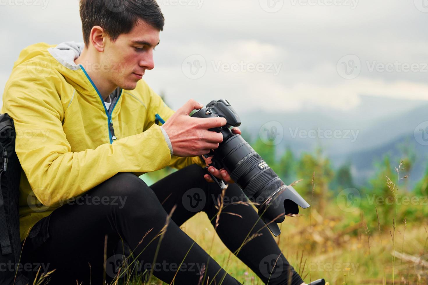 Young photographer makes photos. Majestic Carpathian Mountains. Beautiful landscape of untouched nature photo