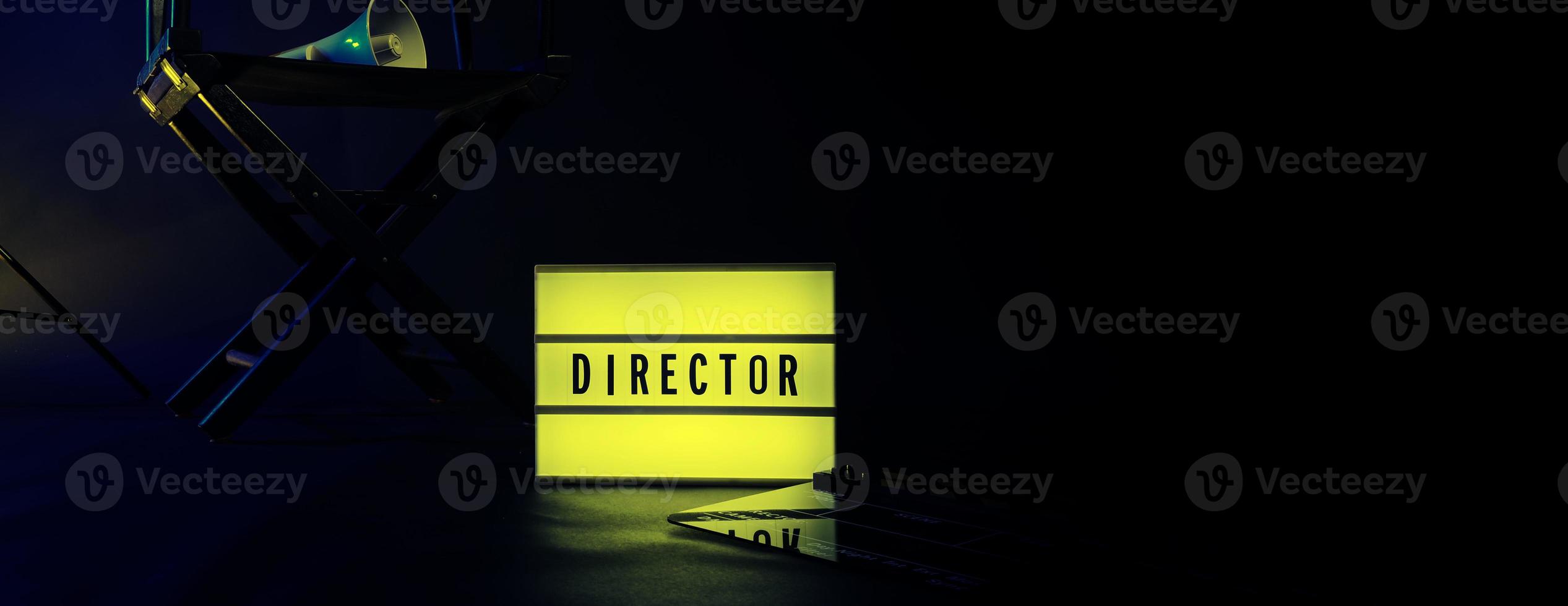 Director chair with cinema lightbox sign Director text on it and clapperboard megaphone photo