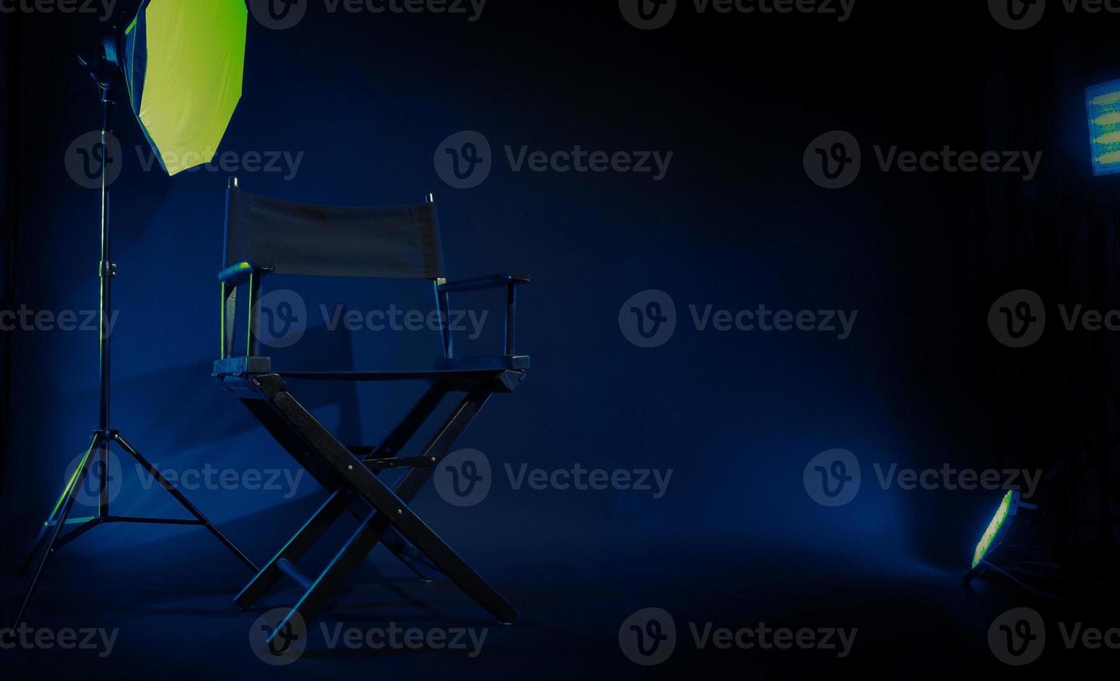 Director chair with cinema lightbox sign Director text on it and clapperboard megaphone photo