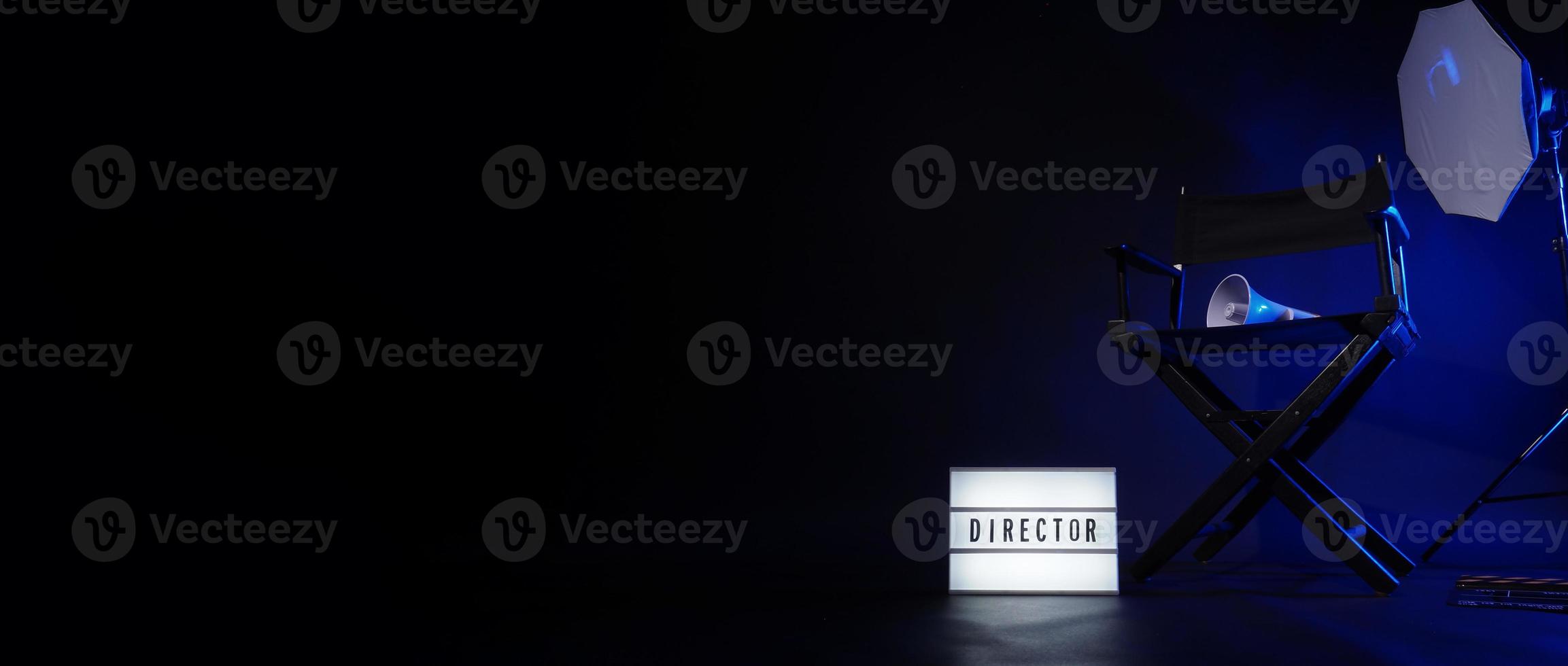Director chair with cinema lightbox sign Director text on it and clapperboard megaphone photo