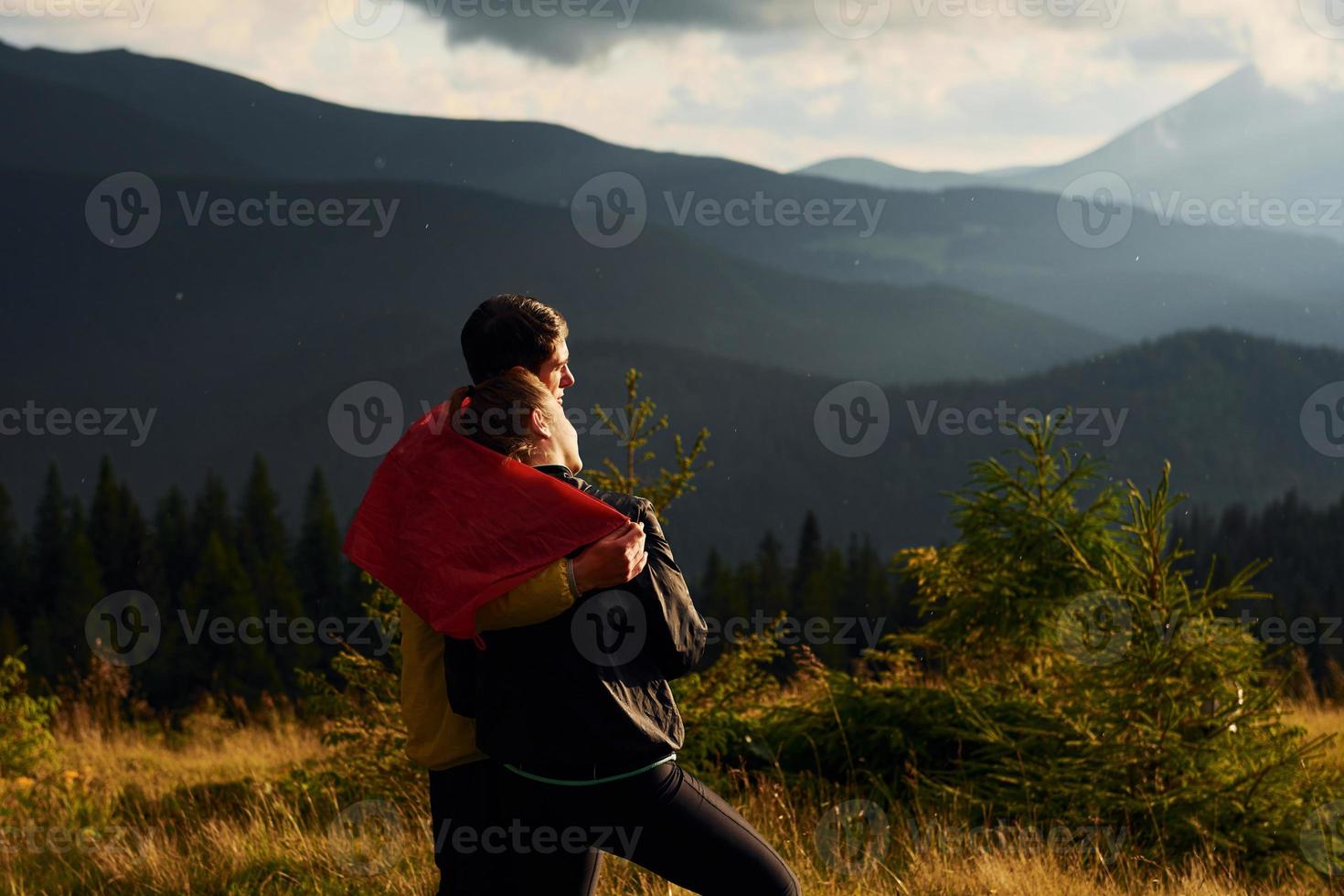 Girlfriend with her boyfriend embracing each other. Majestic Carpathian Mountains. Beautiful landscape of untouched nature photo