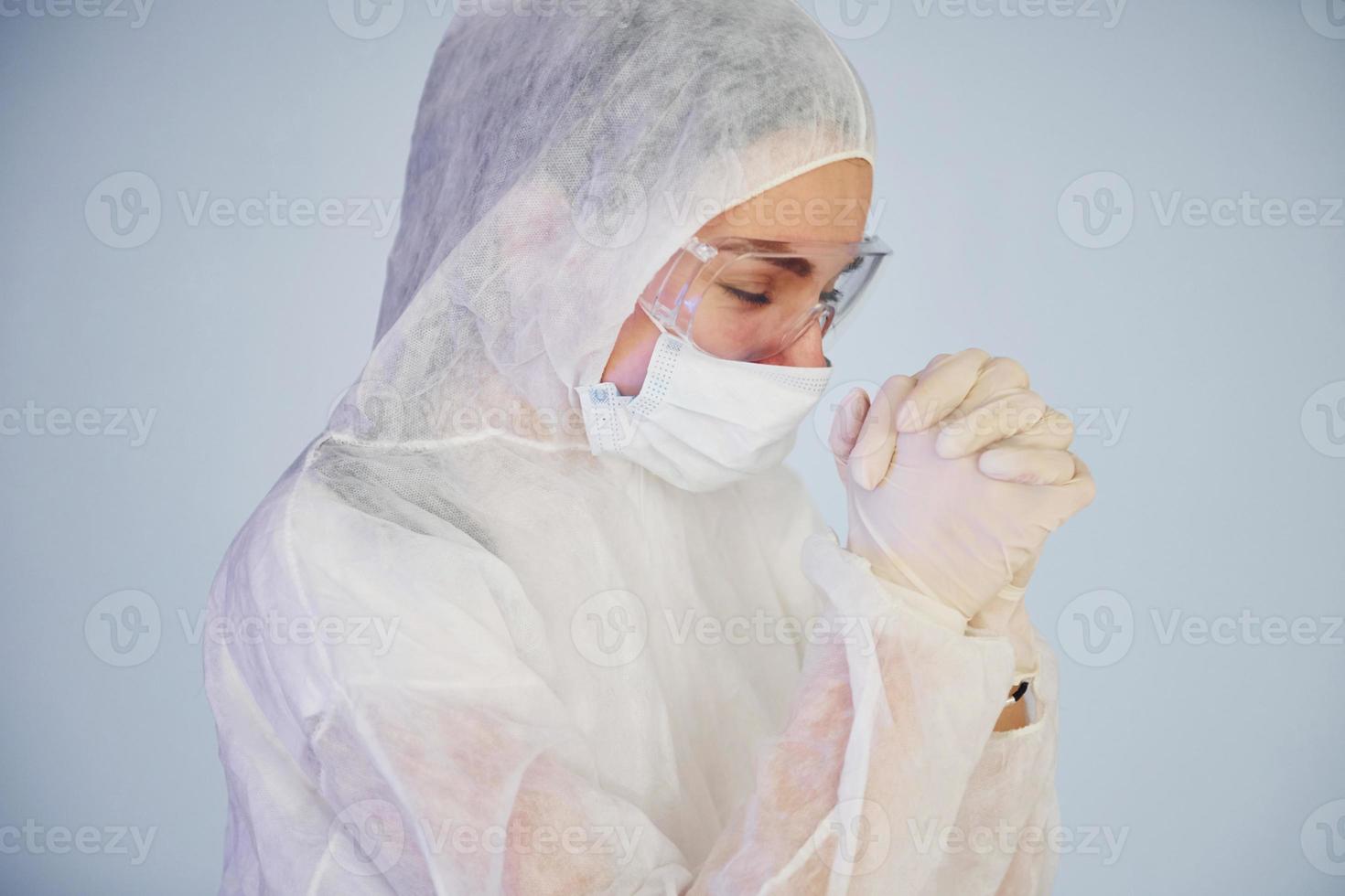 Feeling bad, tired and depressed. Portrait of female doctor scientist in lab coat, defensive eyewear and mask photo