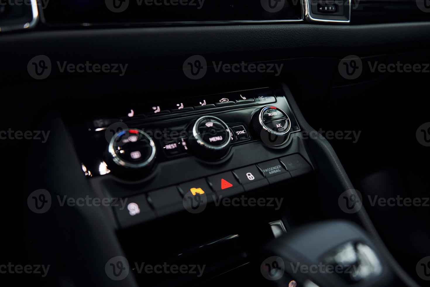 Knobs and buttons. Close up focused view of brand new modern black automobile photo