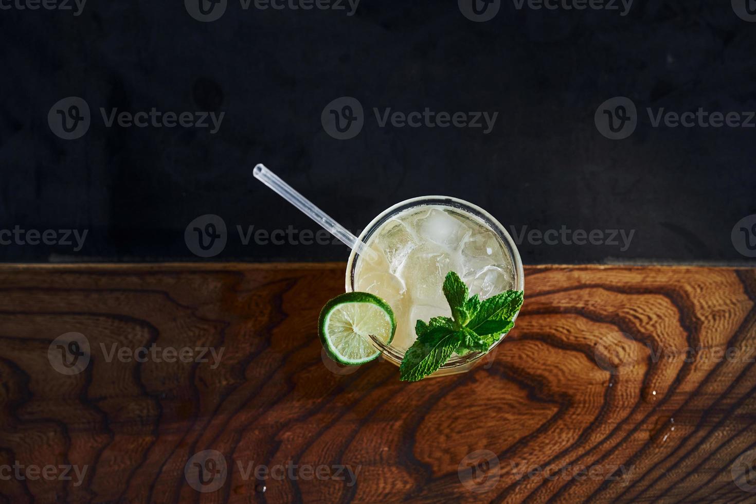 Green mint and yellow lime. Close up view of fresh summer cocktail on the wooden table photo
