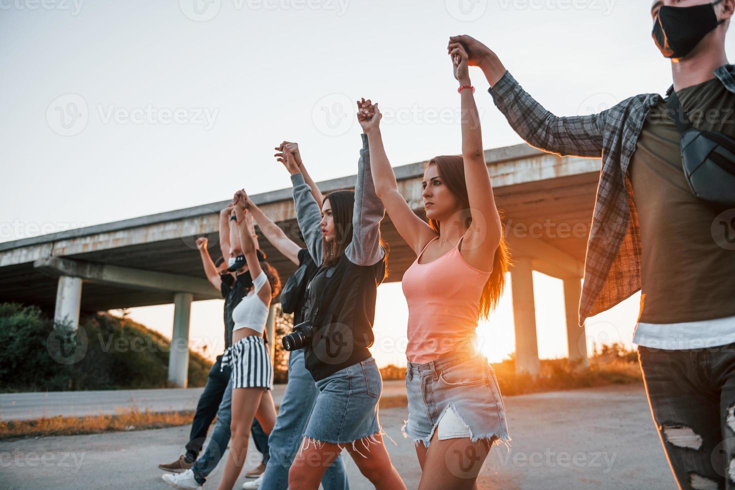 Beautiful sunshine. Group of protesting young people that standing together. Activist for human rights or against government photo