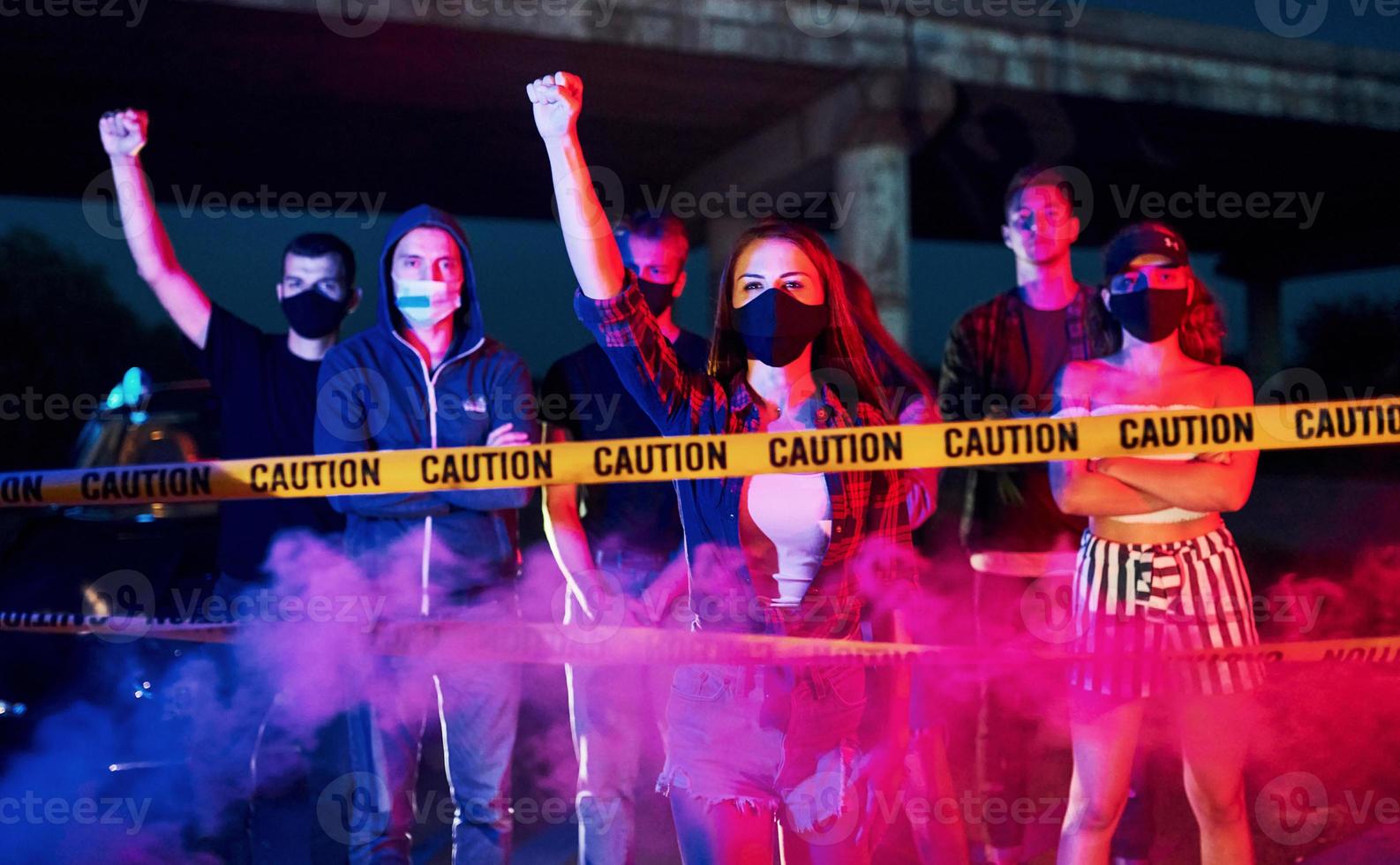 Smoke, fists, police. Group of protesting young people that standing together. Activist for human rights or against government photo