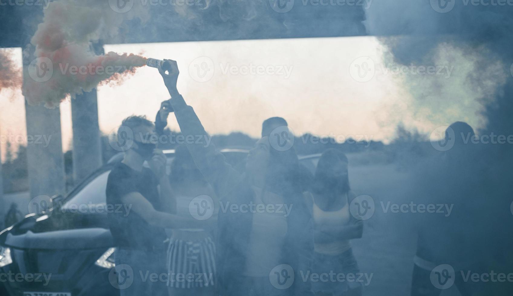 Using smoke. Group of protesting young people that standing together. Activist for human rights or against government photo