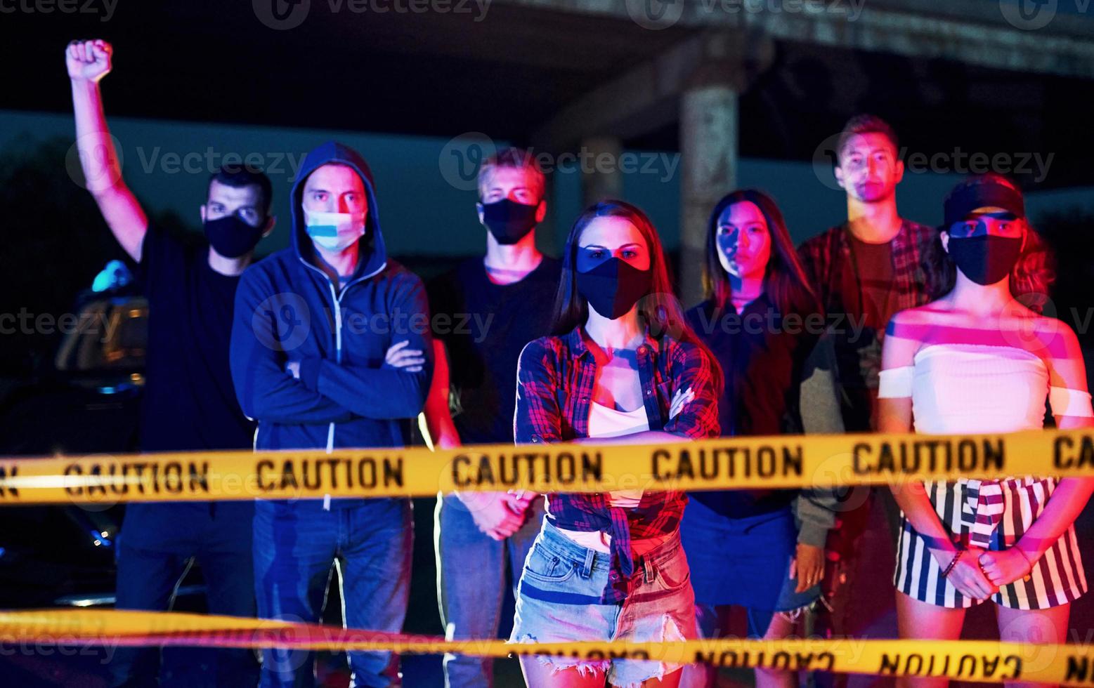 Police line and smoke. Group of protesting young people that standing together. Activist for human rights or against government photo