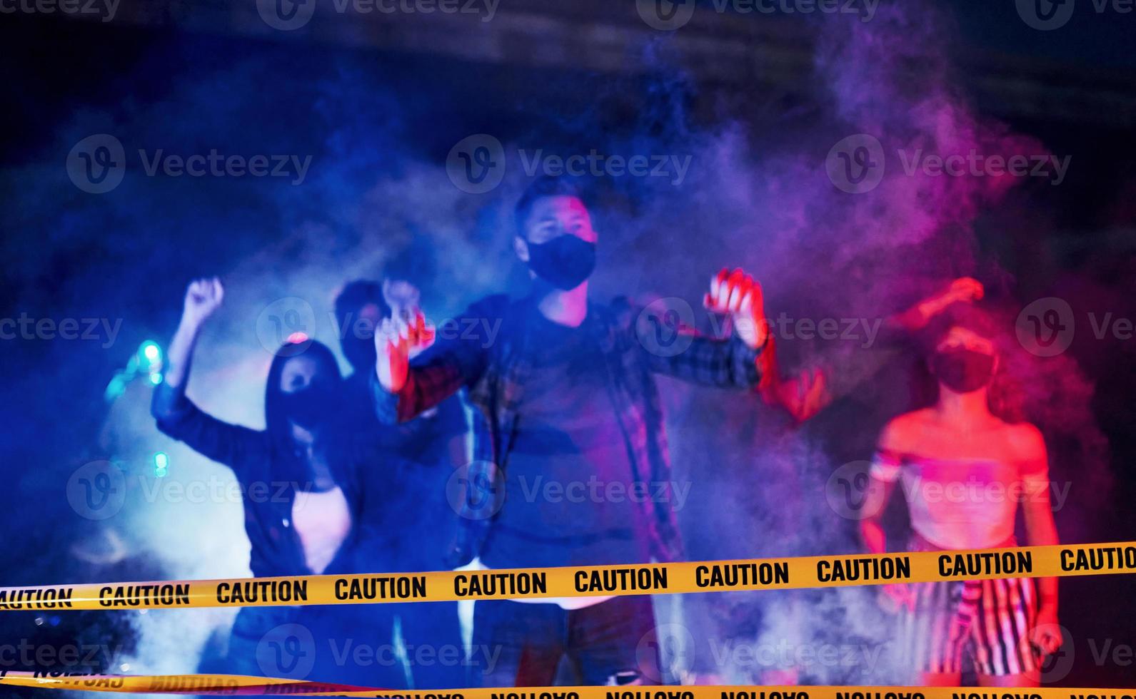 Night of riot. Group of protesting young people that standing together. Activist for human rights or against government photo