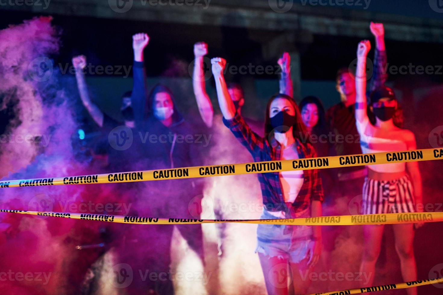 Smoke, fists, police. Group of protesting young people that standing together. Activist for human rights or against government photo