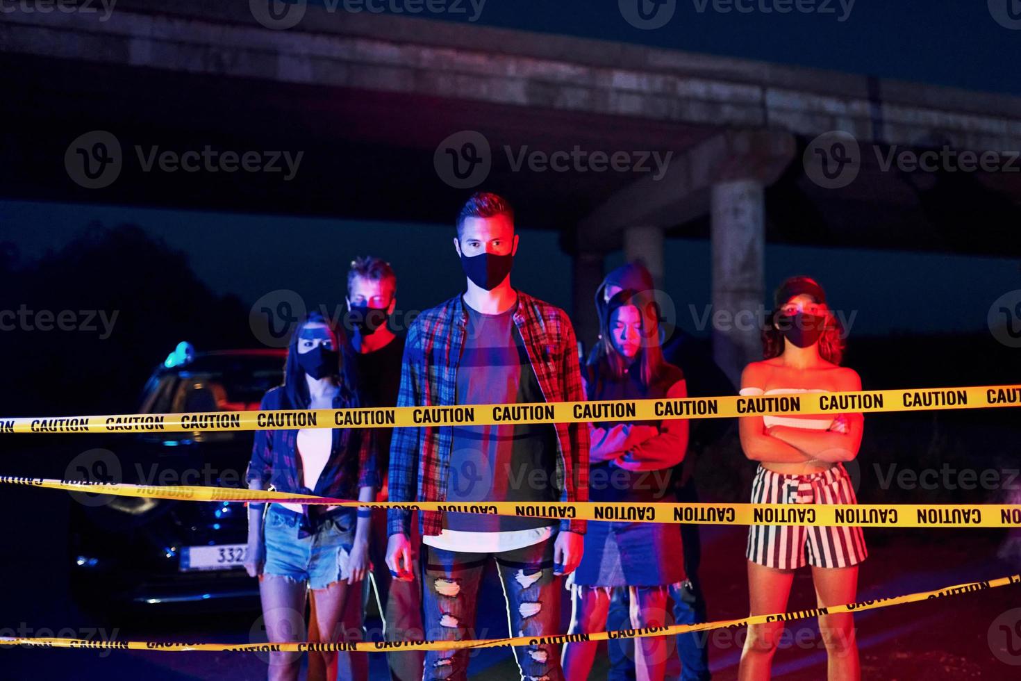 Yellow colored police tape. Group of protesting young people that standing together. Activist for human rights or against government photo