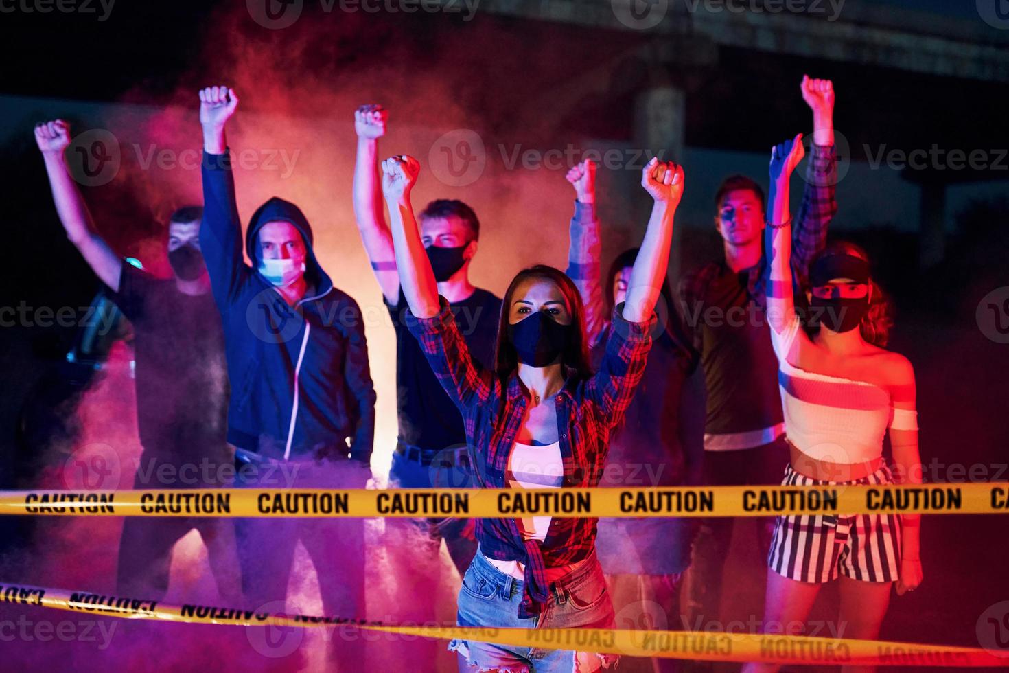 Police line and smoke. Group of protesting young people that standing together. Activist for human rights or against government photo