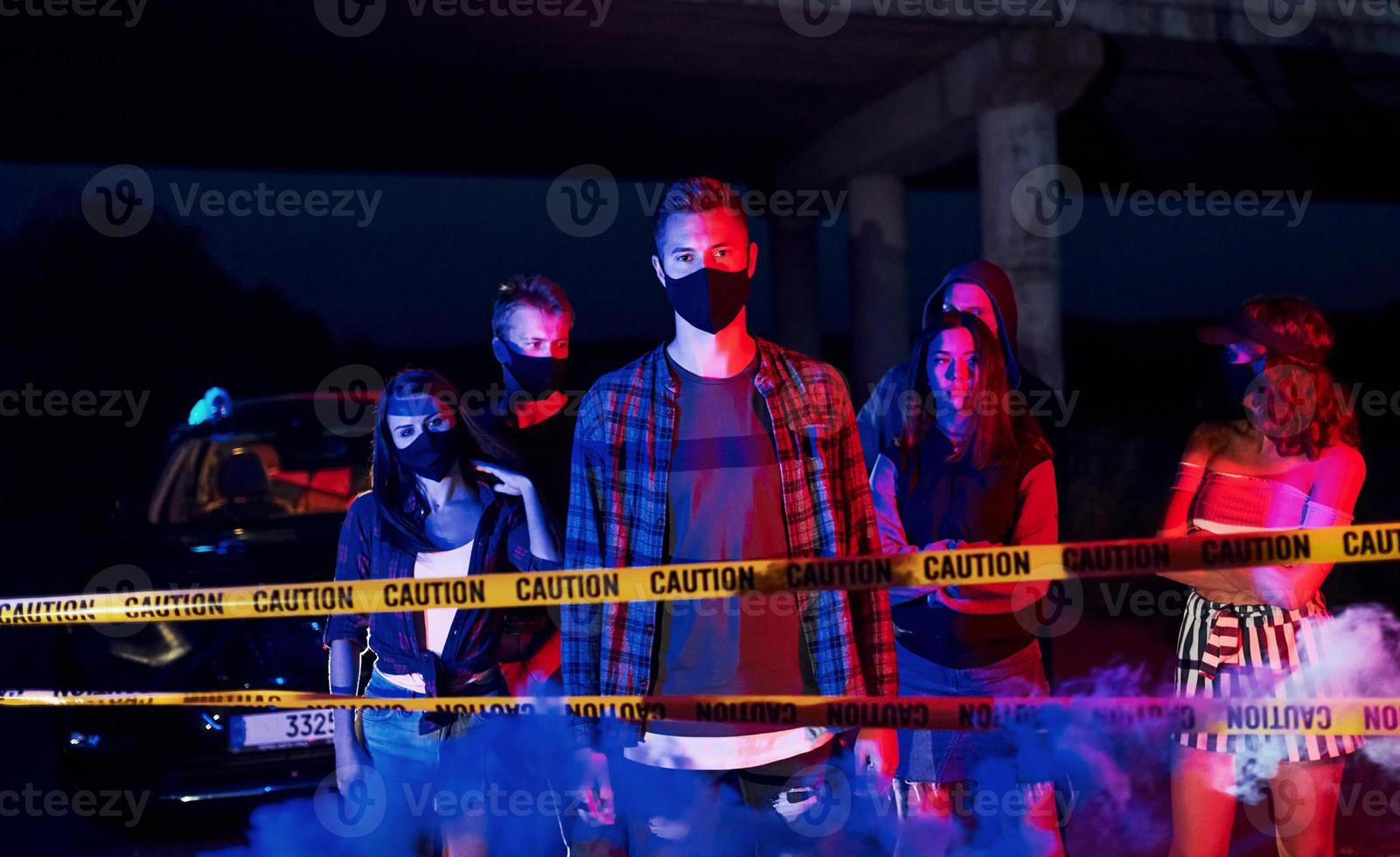 Yellow colored police tape. Group of protesting young people that standing together. Activist for human rights or against government photo