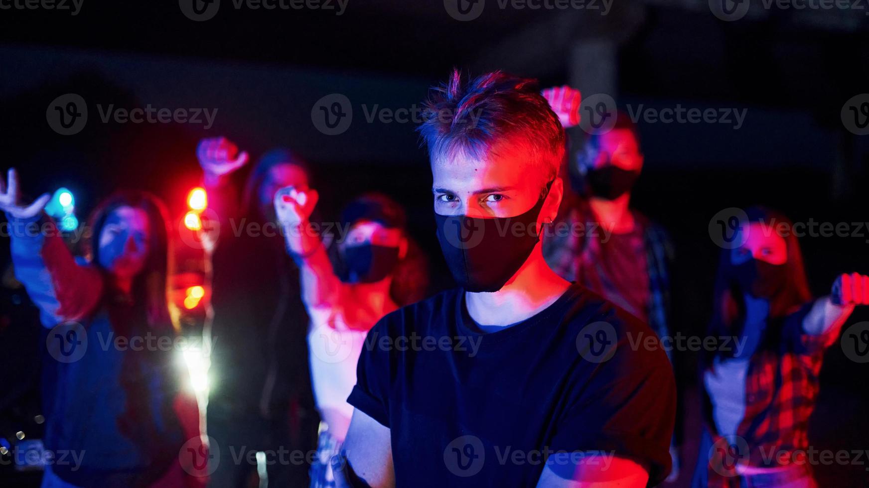 In protective masks. Group of protesting young people that standing together. Activist for human rights or against government photo